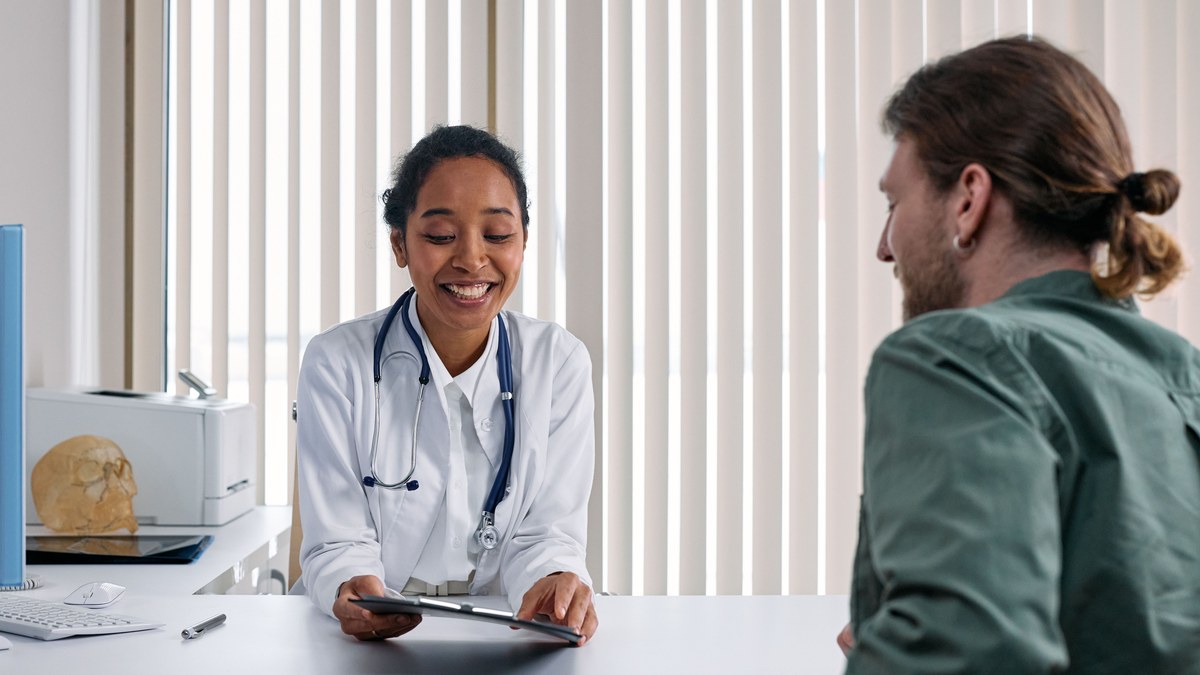 Doctor discussing health insurance coverage with a patient in a clinic
