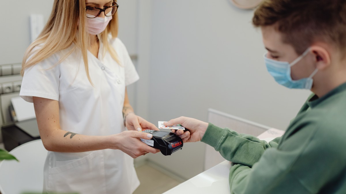 Patient paying healthcare costs by card at a medical clinic